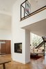 Modern home with Living Room and Two-Sided Fireplace. Two-sided fireplace reaches mezzanine. Photo 7 of Skyline to the Sea House