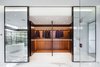 A walk in closet for your suits because you need six suits. Photo 9 of The Floating House modern home
