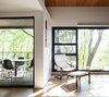 Modern home with Living Room, Chair, Medium Hardwood Floor, and Light Hardwood Floor. Living room - Rue de l'Espéranto residence - Guillaume Sasseville & PARKA - Architecture & Design Photo 5 of Rue de l'Espéranto residence