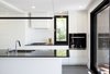 Modern home with Kitchen, White Cabinet, Ceiling Lighting, Ceramic Tile Backsplashe, Ceramic Tile Floor, Track Lighting, Pendant Lighting, Wall Oven, Undermount Sink, and Cooktops. Kitchen - Rue de l'Espéranto residence - Guillaume Sasseville & PARKA - Architecture & Design Photo 7 of Rue de l'Espéranto residence