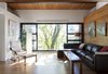 Modern home with Living Room, Sofa, Chair, Sectional, Lamps, Coffee Tables, Floor Lighting, Medium Hardwood Floor, and Light Hardwood Floor. Living room - Rue de l'Espéranto residence - Guillaume Sasseville & PARKA - Architecture & Design Photo of Rue de l'Espéranto residence