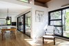 Modern home with Chair, Ceiling Lighting, Lamps, Pendant Lighting, Medium Hardwood Floor, Table, Light Hardwood Floor, White Cabinet, Ceramic Tile Floor, Wall Oven, Ceramic Tile Backsplashe, and Dining Room. Dining room - Rue de l'Espéranto residence - Guillaume Sasseville & PARKA - Architecture & Design Photo 4 of Rue de l'Espéranto residence