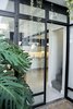 The great window made in glass and steel divides the patio and the dining area. Photo 10 of Artigas modern home