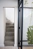 The stairs that used to be out in the patio are now inside thanks to the window and cealing that has been built after them. Photo 13 of Artigas modern home