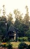 Modern home with Exterior, Cabin Building Type, Metal Roof Material, House Building Type, A-Frame RoofLine, Beach House Building Type, and Wood Siding Material. Kyst Hus - cabin with front doors open to the garden. Photo 4 of Kyst Hus A Frame