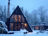 Modern home with Exterior, Metal Roof Material, Beach House Building Type, Wood Siding Material, A-Frame RoofLine, and Cabin Building Type. Kyst Hus - Cabin and studio. The library is visible on the loft wall. Photo 2 of Kyst Hus A Frame