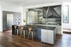 Modern home with Kitchen, Recessed Lighting, Wood Cabinet, Refrigerator, Wall Oven, Undermount Sink, Marble Backsplashe, and Range. Custom steel vent hood designed by West Architecture Studio and fabricated by Luke Prestridge. Photo 3 of Alaska House
