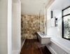Modern home with Bath Room and Dark Hardwood Floor. Highly-engineered floating steel and wood bath vanity/sink designed by West Architecture Studio and fabricated by Luke Prestridge and Timberland Cabinetry. Custom mirror that also acts as tub filler. Photo 5 of Alaska House
