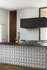 Modern home with Kitchen, White Cabinet, Range, Undermount Sink, Medium Hardwood Floor, Ceramic Tile Backsplashe, and Range Hood. Custom floating blackened steel hood designed by West Architecture Studio and fabricated by Luke Prestridge Photo of Tesseract House