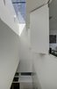 The bridge looks down to the kitchen and across in to the upper level rumpus room. Solid bi-fold shutters enable the rumpus space to be opened up to connect to the ground floor living spaces. Photo 6 of Inner West House modern home