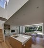 The view to the garden is across a sequence of spaces - the kitchen / living / dining spaces extend onto a covered loggia, a thermally controlled indoor / outdoor space for year round comfort. Photo 7 of Inner West House modern home