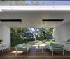 The garden room frames the landscape and becomes an extension of the interior spaces. White painted lining boards wrap the space and echo the traditional palette of the cottage. Photo 8 of Inner West House modern home