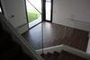 Modern home with Medium Hardwood Floor and Dining Room. Salon con escalera incorporada. Photo 7 of CASA FLORES