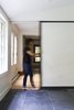 A sliding wall divides the veranda space from the living room, allowing the occupants to modulate the space according to their needs. Photo 6 of L'Eau Vive modern home