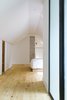 Modern home with Bedroom, Wardrobe, Bed, Ceiling Lighting, Wall Lighting, and Light Hardwood Floor. The master bedroom’s simple design highlights the ancestral chimney. Photo 8 of L'Eau Vive