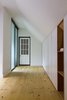Modern home with Bedroom, Wardrobe, Shelves, Ceiling Lighting, and Light Hardwood Floor. The master bedroom is equipped with built-in furniture in the lower part of the roof and with a small private bathroom. Photo 9 of L'Eau Vive
