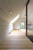 Modern home with Office, Study Room Type, Desk, Chair, Lamps, and Light Hardwood Floor. The walkway separates the master bedroom from the private mezzanine made to be an office. Photo 10 of L'Eau Vive