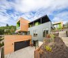 Modern home with Exterior, House Building Type, Wood Siding Material, and Metal Siding Material. Stacked volumes stepping up the slope Photo of Panavista Hill House