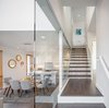 Modern home with Staircase, Wood Tread, and Glass Railing. The floating stairs opening to each split level Photo 5 of Lightbox 23