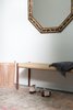 Entry featuring a DWR bench, vintage Turkish rug, and Moroccan mirror. Photo of Laurel Heights Residence modern home