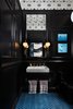 Fireclay Tile in Adriatic Sea and a marble sink and brass faucet from Kohler pop off of the black high gloss walls. Photo of 2017 San Francisco Decorator Showcase modern home