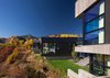 Modern home with Outdoor, Shrubs, Slope, Grass, Small Patio, Porch, Deck, Side Yard, and Concrete Fences, Wall. Inspired by breathtaking panoramic views of the Elk Mountain Range, this 9,918 SF, 5-bedroom mountain retreat was designed for family time and entertaining. © Copyright CCY Architects. Photo of Maroon Creek Overlook