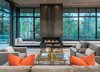 Modern home with Living Room, Gas Burning Fireplace, Ottomans, Table, Bench, Concrete Floor, and Sofa. Red Butte Living Room - CCY Architects worked with Jack Kearney with Company K out of Seattle to create the "Book Matched" effect on the simplistic showpiece steel fireplace. Photo of Red Butte
