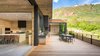 Modern home with Dining Room, Concrete Floor, Storage, Medium Hardwood Floor, Table, Stools, Chair, and Recessed Lighting. CCY Architects | Red Butte Indoor Outdoor Living - The clients wanted an “Aspen/Mountain Beach House” that felt like their modern, and subtle but sophisticated beach house in Texas. They wanted to relax and have the home feel unassuming and wanted space for entertaining friends and family.
.
Photo 9 of Red Butte