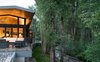 Modern home with Exterior, House Building Type, Wood Siding Material, and Stone Siding Material. Situated near a creek that flows below a steep embankment, the house sits between an open pasture and a dense Cottonwood grove. Photo 2 of Woody Creek Residence