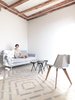 The hand-made tiles are placed in a evolving pattern, not repeated. Chair by manolito& Manolita ( Cometa Architects), tables by Fragmenst Bcn, Sofa by Pilma Photo 6 of LIGHTSLICE apartment modern home