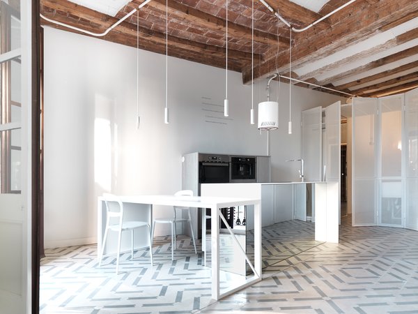 The white kitchen is undeniably the focal point of the house. All lighting is custom made by the architects, Faidra Matziaraki and Victor Gonzalez Marti.

