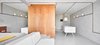 Modern home with Living Room, Bench, Sofa, Wall Lighting, and Concrete Floor. Interior Photo 16 of The Marina Apartment