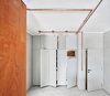 Modern home with Kitchen, Wood Counter, Refrigerator, Concrete Counter, Concrete Floor, Wood Cabinet, Ceiling Lighting, and Wine Cooler. Entrance along with built in closets, fridge & vinotecca Photo 2 of The Marina Apartment