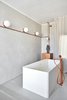 Modern home with Concrete Floor, Wall Lighting, and Concrete Counter. free standing bathtub and custom made fixtures & fossets Photo 20 of The Marina Apartment