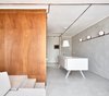Modern home with Kitchen, Wall Lighting, Microwave, Concrete Counter, Ceiling Lighting, Drop In Sink, Wine Cooler, Concrete Floor, and White Cabinet. Kitchen Island Photo 15 of The Marina Apartment