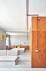 Modern home with Living Room, Sofa, Wall Lighting, Bench, and Concrete Floor. Living and Sleeping area Photo 12 of The Marina Apartment