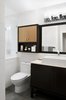 The guest bathroom is more of a minimal, white space, with wood accents to bring in the elements of nature. The vanity was purchased from Kohler, but the mirror and cabinetry above was custom designed and built to coordinate with the vanity below, and add storage. The wall tile, although white, has a unique geometric pattern to it which created more interest in the bright space.
Photo of West Coast Pied A Terre modern home