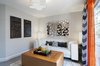 The home office area was meant to be a refuge and the place where our client would spend a lot of time both working and relaxing. It needed to be bright and airy, modern, but comfortable. We used neutral grey paint on the walls, bold chevron curtains, and bespoke whitewash wood floors. The orange and bronze accents throughout were brought in in order to contrast against the black, white and grey main elements of the space. Two modern end tables on either side of the sofa with Zebra wood tops, also offer a touch of warmth and contrast. Photo 3 of West Coast Pied A Terre modern home