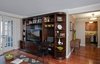 We added a new header over the space that connects the living room into the foyer in order to help define the space. We also added some crown and base moldings, and new wood floors throughout for a richer, more detailed look.
Photo 4 of Dog Lover's Apartment modern home
