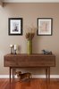 With a stroke of luck (and a great photographer!) we captured the family Dachshund under the walnut wood mid-century credenza in the foyer. The tinier, inanimate version of the Dachshund on the credenza, is a ceramic sculpture we found from from Jonathan Adler.
Photo 2 of Dog Lover's Apartment modern home