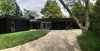 Modern home with Exterior, Glass Siding Material, Wood Siding Material, Flat RoofLine, Mid-Century Building Type, Concrete Siding Material, and House Building Type. Facade Photo of Prévert