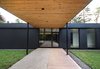 Modern home with Exterior, Wood Siding Material, Mid-Century Building Type, Concrete Siding Material, Flat RoofLine, Glass Siding Material, and House Building Type. Front door Photo 4 of Prévert