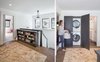 Upstairs landing accommodates book storage and discrete laundry closet Photo 6 of Grant Park Dutchie modern home