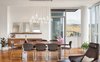 Custom, hand-blown, multi-pendant glass fixture floats above the dining table Photo 3 of Atwater modern home
