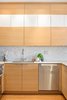 Modern home with Wood Cabinet, Stone Tile Backsplashe, White Cabinet, Medium Hardwood Floor, Mosaic Tile Backsplashe, Recessed Lighting, Ceiling Lighting, Pendant Lighting, Refrigerator, Cooktops, Range, Undermount Sink, and Kitchen. Pops of white enhance the warm wood tones Photo 2 of Tanner Place
