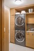 Modern home with Wood Cabinet, Pendant Lighting, Medium Hardwood Floor, White Cabinet, Stone Tile Backsplashe, Mosaic Tile Backsplashe, Refrigerator, Cooktops, Range, Undermount Sink, Dishwasher, Chair, Table, Ceiling Lighting, Study Room Type, Library Room Type, Storage, Shelves, Desk, and Alcove Tub. An organizing system keeps the laundry room neat and accessible Photo 8 of Tanner Place
