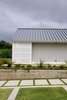 Modern home with Exterior, Metal Roof Material, Wood Siding Material, and House Building Type. Upcountry Maui Cottage and Barn: Cottage lanai screen detail Photo 14 of Haiku Maui