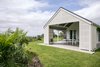 Modern home with Outdoor, Shrubs, Wood Patio, Porch, Deck, Trees, Front Yard, Grass, Large Patio, Porch, Deck, and Concrete Patio, Porch, Deck. Upcountry Maui Cottage and Barn: lanai Photo 11 of Haiku Maui