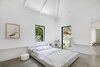 Modern home with Bedroom, Bed, and Night Stands. Henkin Shavit's modernist farmhouse combines traditional and modern with its high ceilings, singular color palette, and its organization of private and public spaces. Photo 4 of A Modernist Farmhouse
