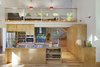 Modern home with Metal Counter, Wood Cabinet, Medium Hardwood Floor, Ceramic Tile Backsplashe, Pendant Lighting, Refrigerator, Wall Oven, Microwave, Undermount Sink, Range, Range Hood, and Living Room. Kitchen and Loft Photo 5 of Sliwinski Residence